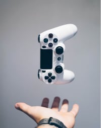 person throwing up a console controller